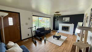 Living room featuring a fireplace and wood-type flooring