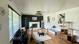 Living room with a fireplace and wood finished floors