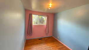 Unfurnished room featuring light wood-style floors and baseboards