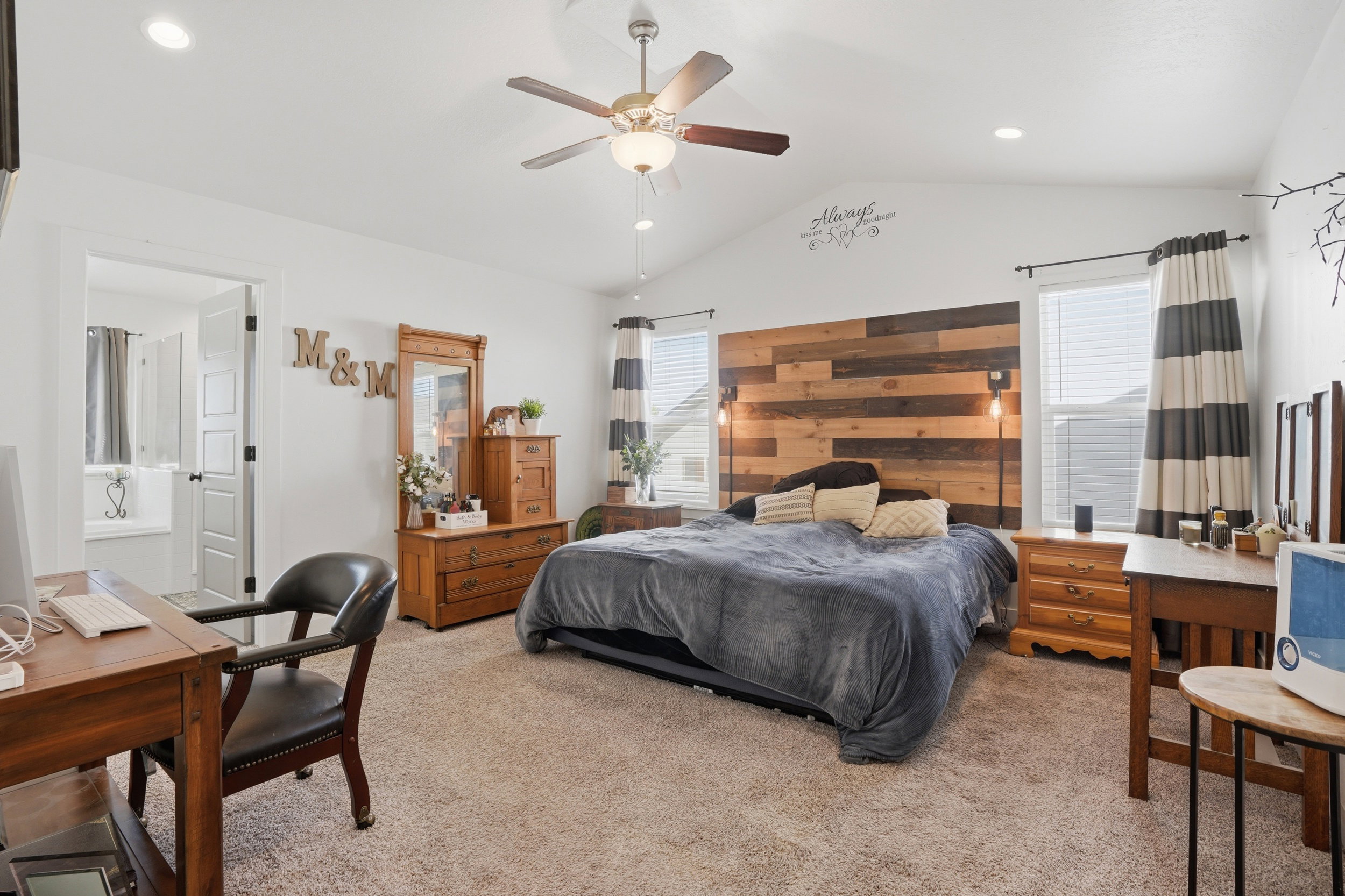 Bedroom featuring light colored carpet, recessed lighting, ceiling fan, and ensuite bathroom