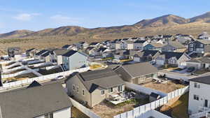View of mountain backdrop featuring nearby suburban area