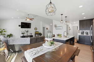Dining area featuring light wood-type flooring, a ceiling fan, recessed lighting, and lofted ceiling