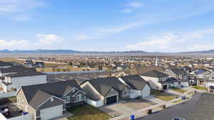 Aerial perspective of suburban area featuring a mountain backdrop