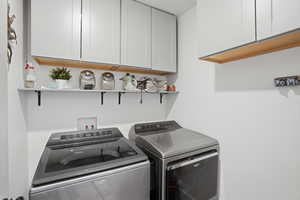Laundry area featuring cabinet space and washer and dryer