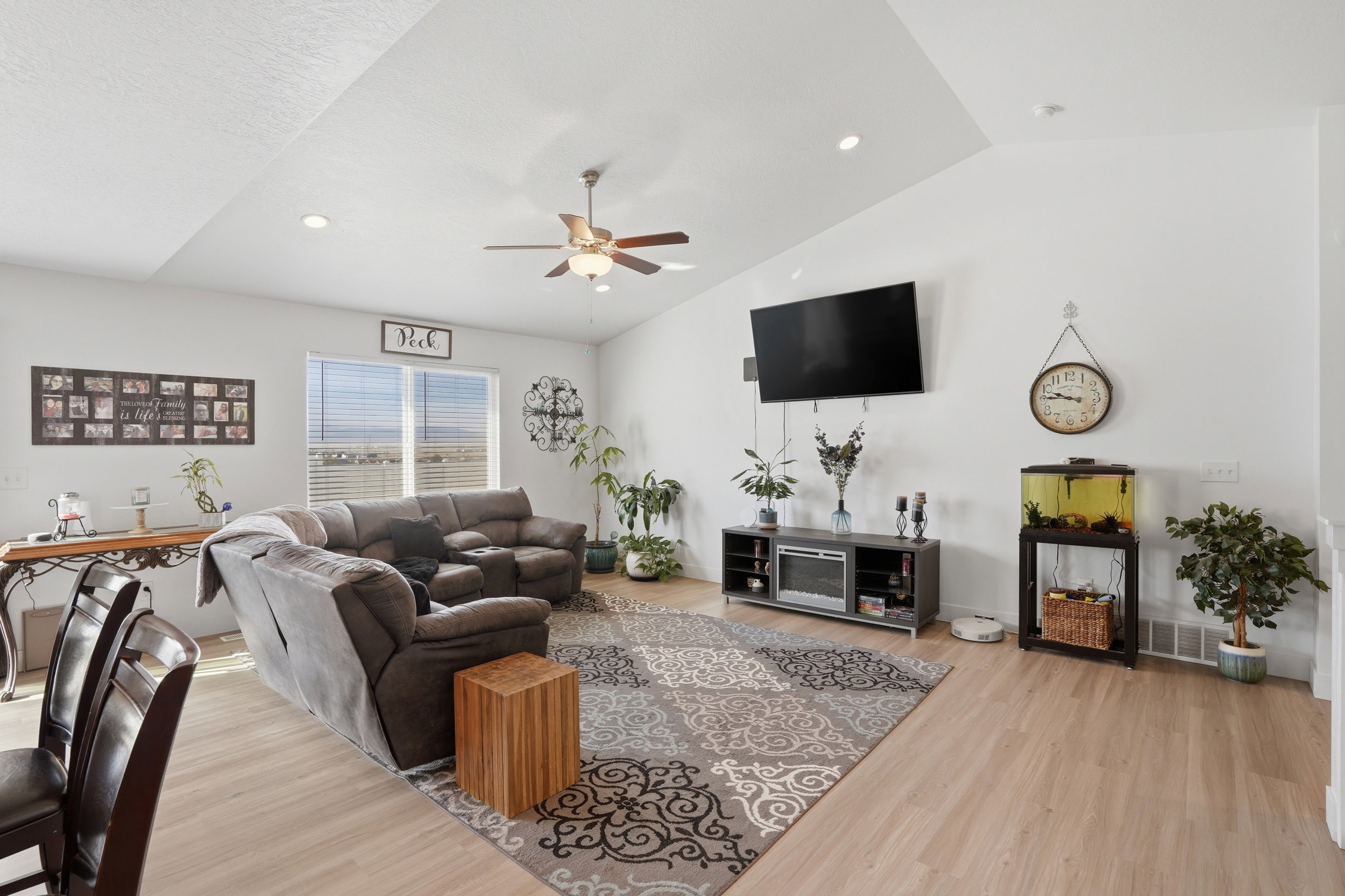 Living area with a ceiling fan, light wood-style floors, lofted ceiling, and recessed lighting
