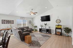 Living area with a ceiling fan, light wood-style floors, lofted ceiling, and recessed lighting