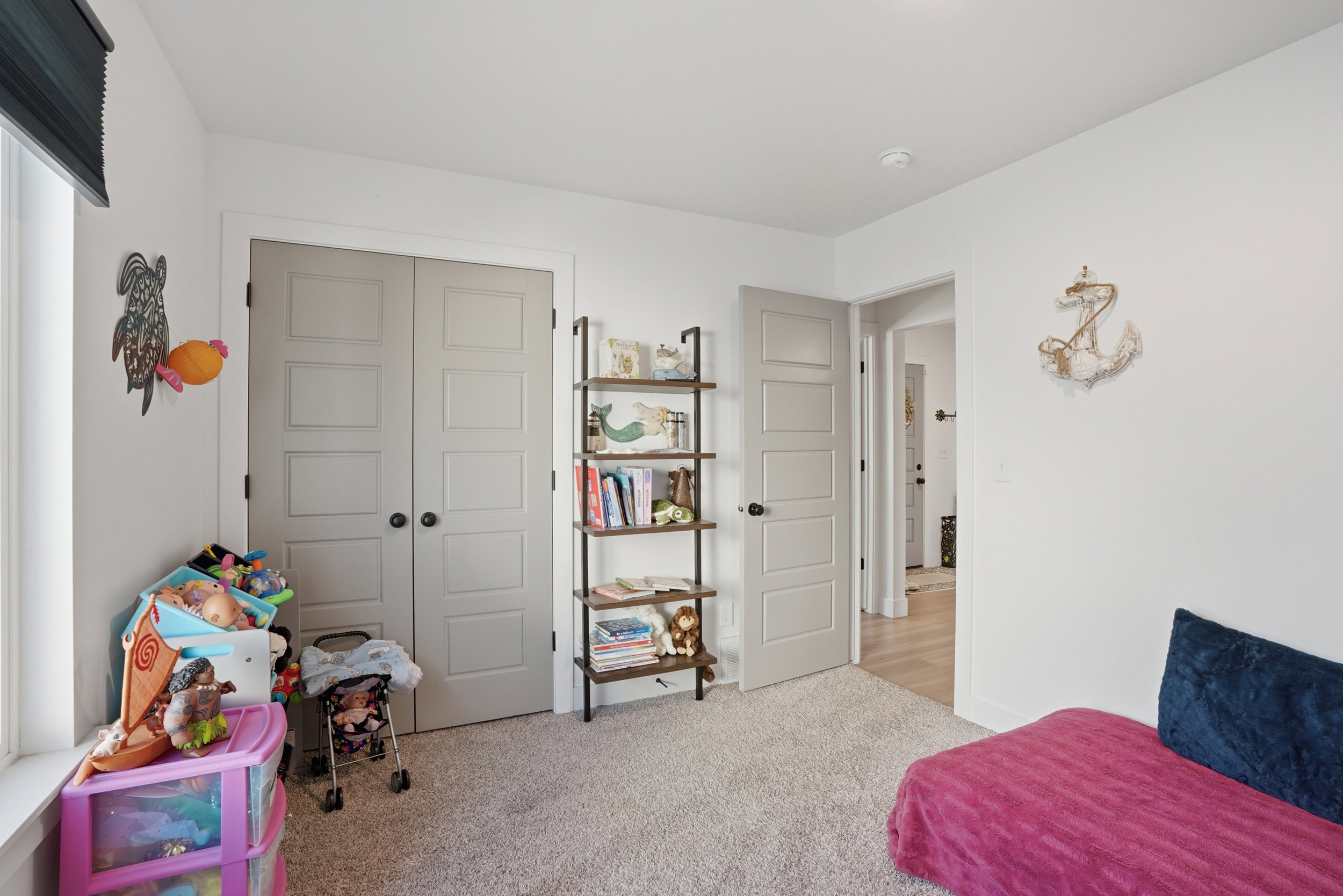 Bedroom featuring light carpet and a closet