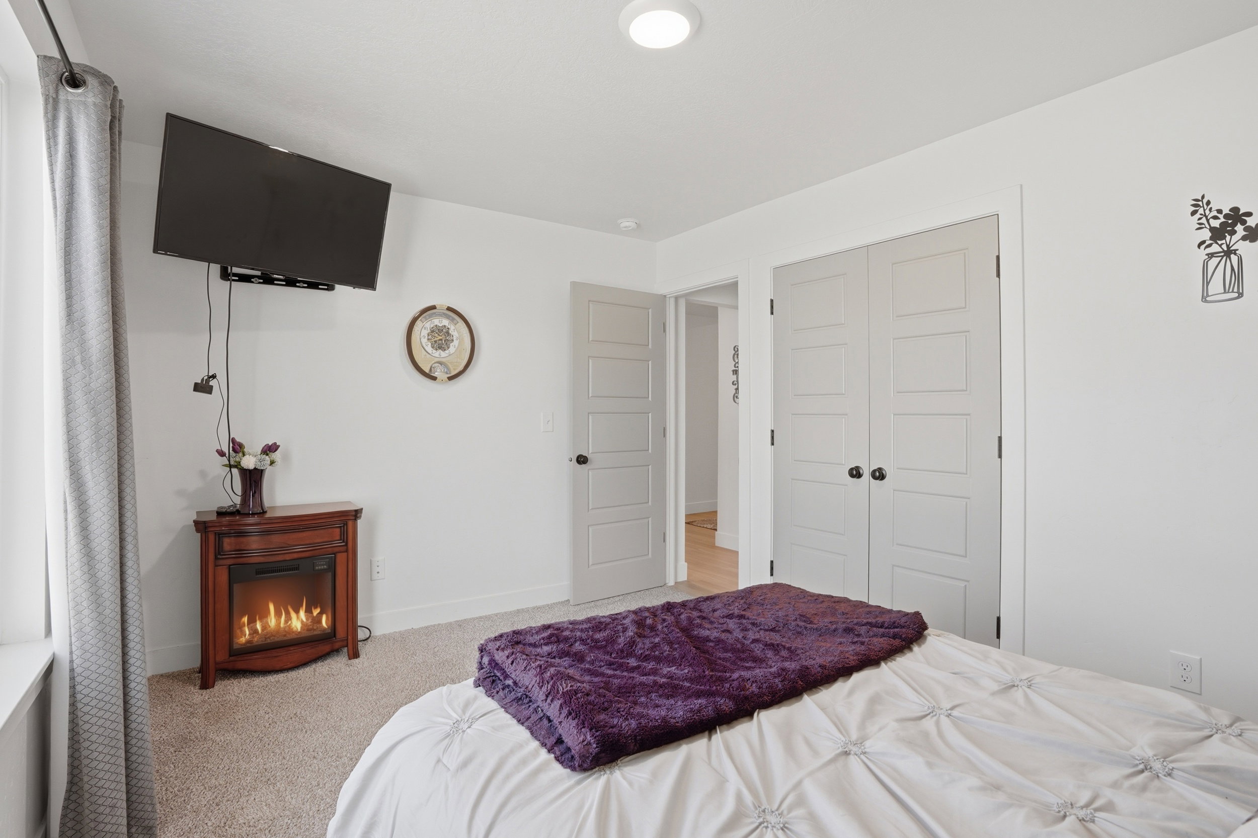 Bedroom featuring light colored carpet and a closet