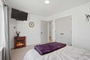 Bedroom featuring light colored carpet and a closet