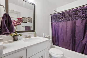 Full bath featuring vanity and shower / bath combo with shower curtain
