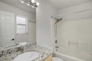 Full bath featuring vanity and shower / washtub combination