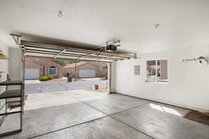 Garage with electric panel and a garage door opener