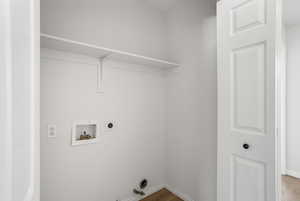 Laundry area featuring gas dryer hookup, hookup for a washing machine, light wood finished floors, and hookup for an electric dryer