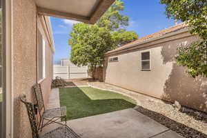 Fenced backyard with a patio