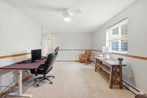 Office space with light carpet, a baseboard radiator, and ceiling fan