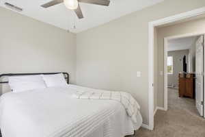Bedroom featuring carpet flooring, a ceiling fan, and a baseboard radiator