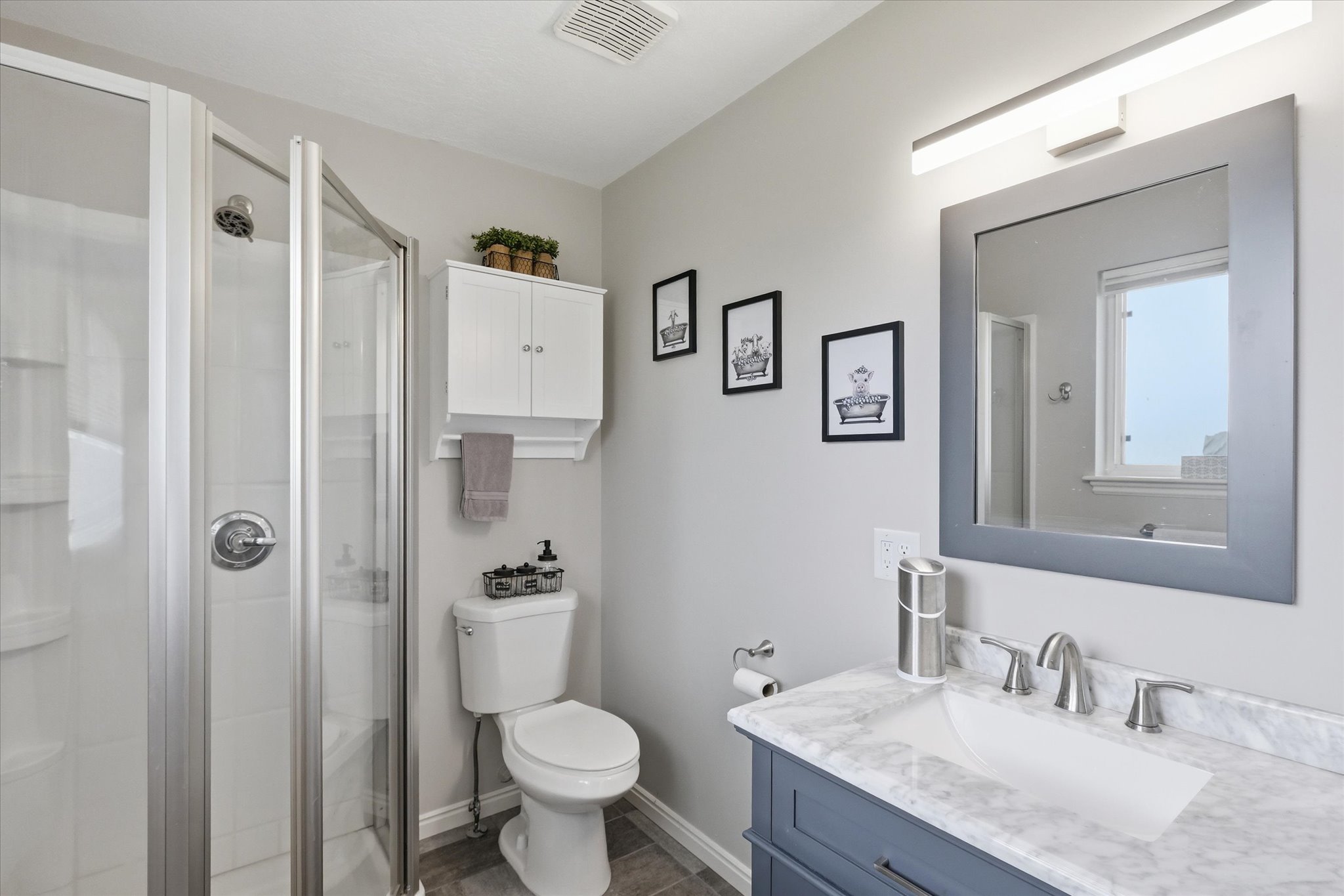 Full bathroom with vanity and a stall shower