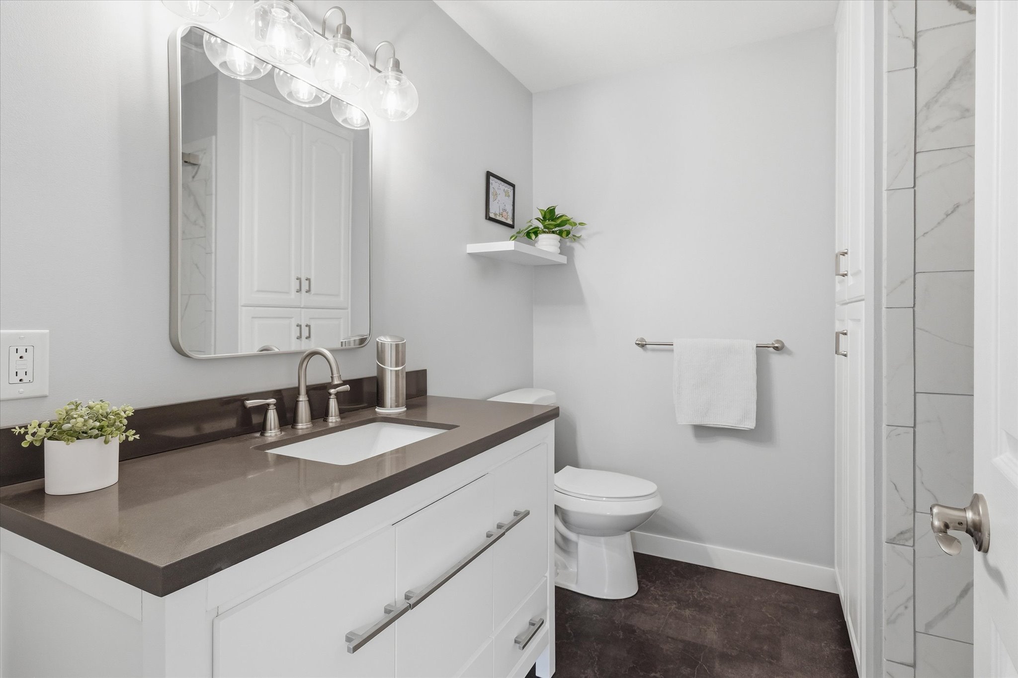 Bathroom featuring vanity and a closet