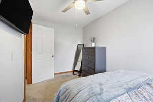 Bedroom featuring light colored carpet and ceiling fan