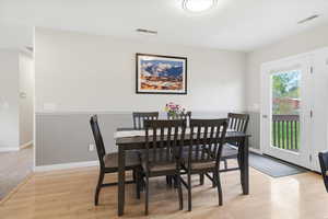 Dining space with light wood-type flooring and baseboards