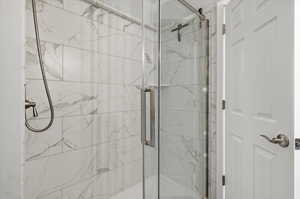 Bathroom with a marble finish shower