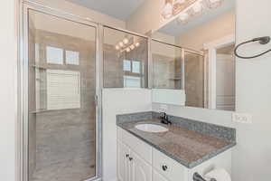Bathroom with vanity and a stall shower