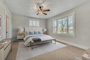 Bedroom featuring ceiling fan and light carpet