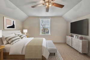 Carpeted bedroom featuring ceiling fan and a textured ceiling