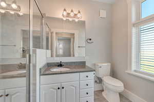 Full bath featuring vanity and a shower stall