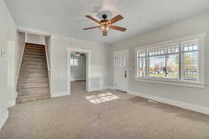 Foyer featuring light carpet and ceiling fan