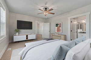 Bedroom with ceiling fan and light colored carpet