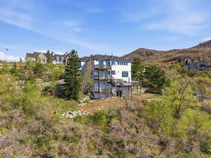 Back of house with a mountain view and a residential view