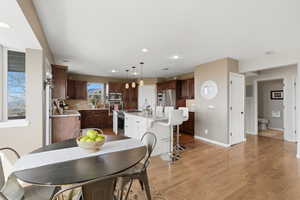 Dining area featuring light wood finished floors and recessed lighting
