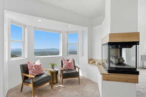 Sitting room featuring carpet flooring, a mountain view, recessed lighting, and a multi sided fireplace