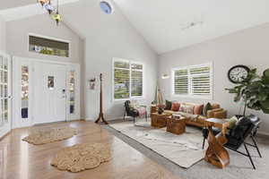 Entrance foyer with vaulted ceiling and wood finished floors