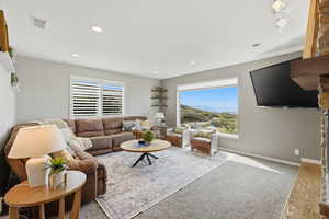 Living area with healthy amount of natural light and light carpet