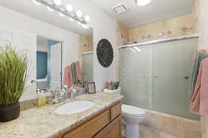 Bathroom featuring vanity and a stall shower