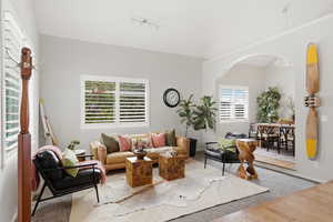 Living room featuring baseboards and arched walkways