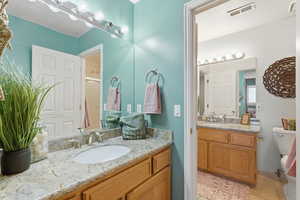 Full bath with two vanities and a shower stall
