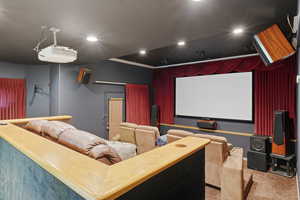 Cinema room featuring carpet floors, recessed lighting, and ornamental molding