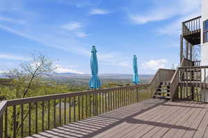 Deck with stairway and a mountain view