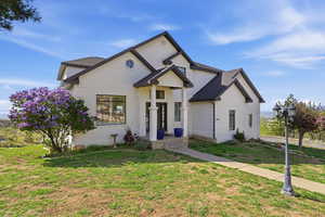 View of front of house featuring brick siding and a front lawn