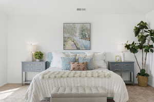 Bedroom featuring carpet flooring and vaulted ceiling