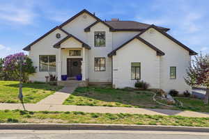 View of front of house with a front lawn and brick siding