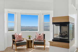 Living area featuring carpet floors, plenty of natural light, and recessed lighting