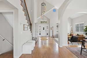 Entryway featuring light wood-type flooring and lofted ceiling