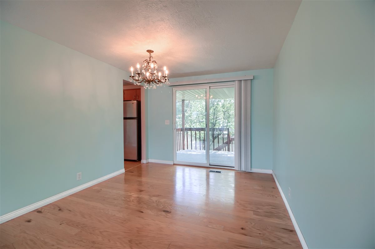 Empty room featuring a chandelier and light wood finished floors