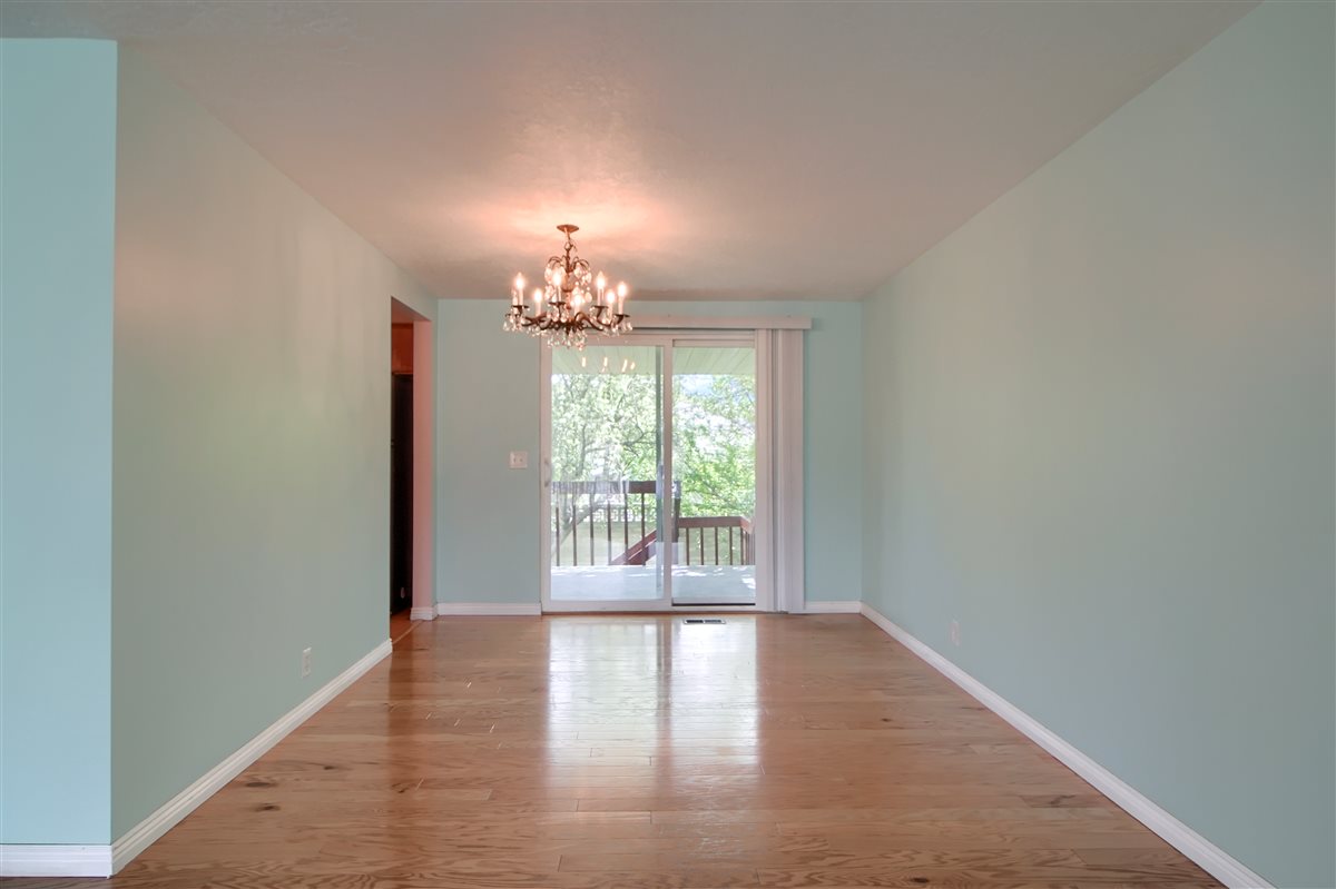 Unfurnished dining area featuring light wood-style floors and a chandelier
