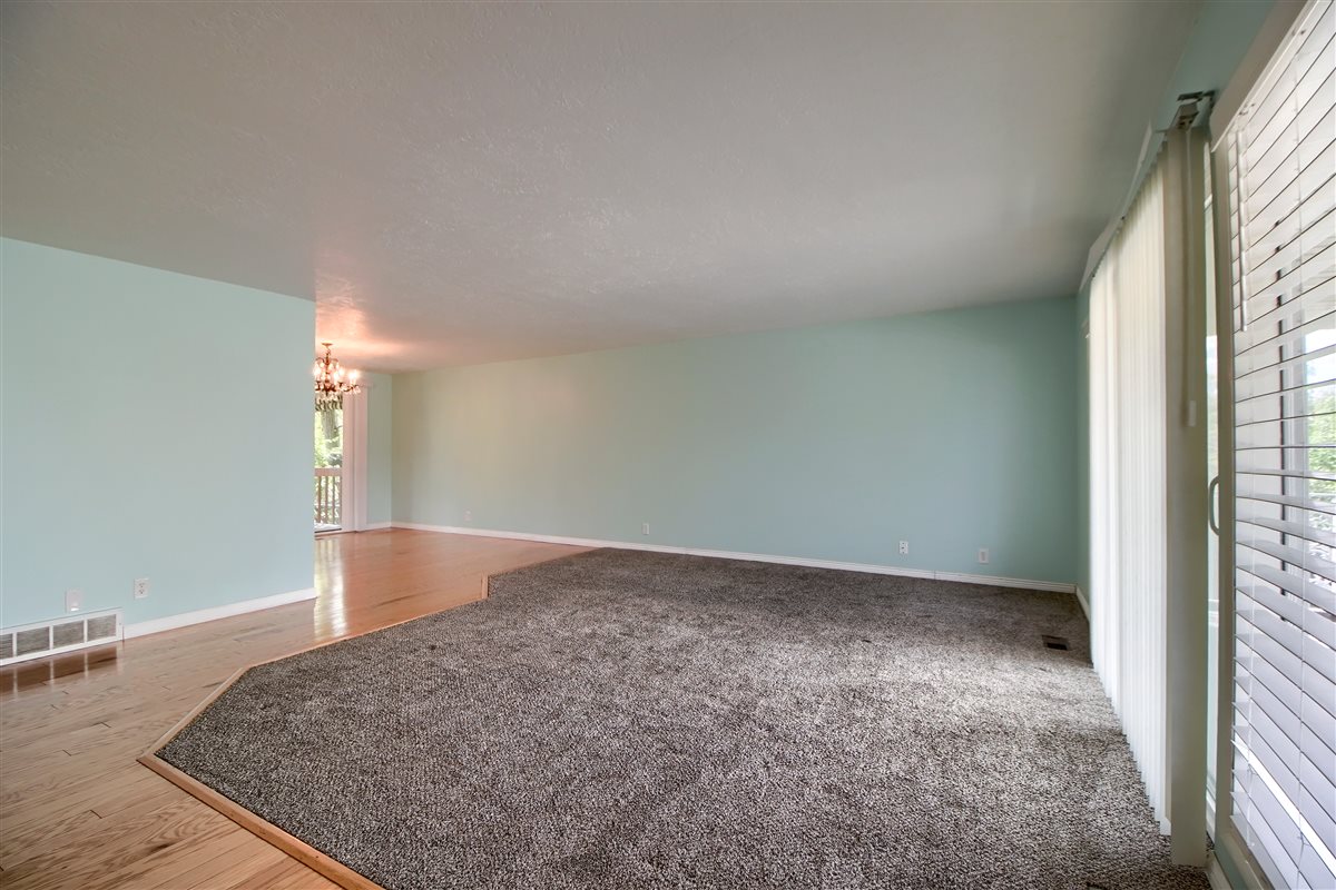 Unfurnished room featuring a chandelier and wood finished floors