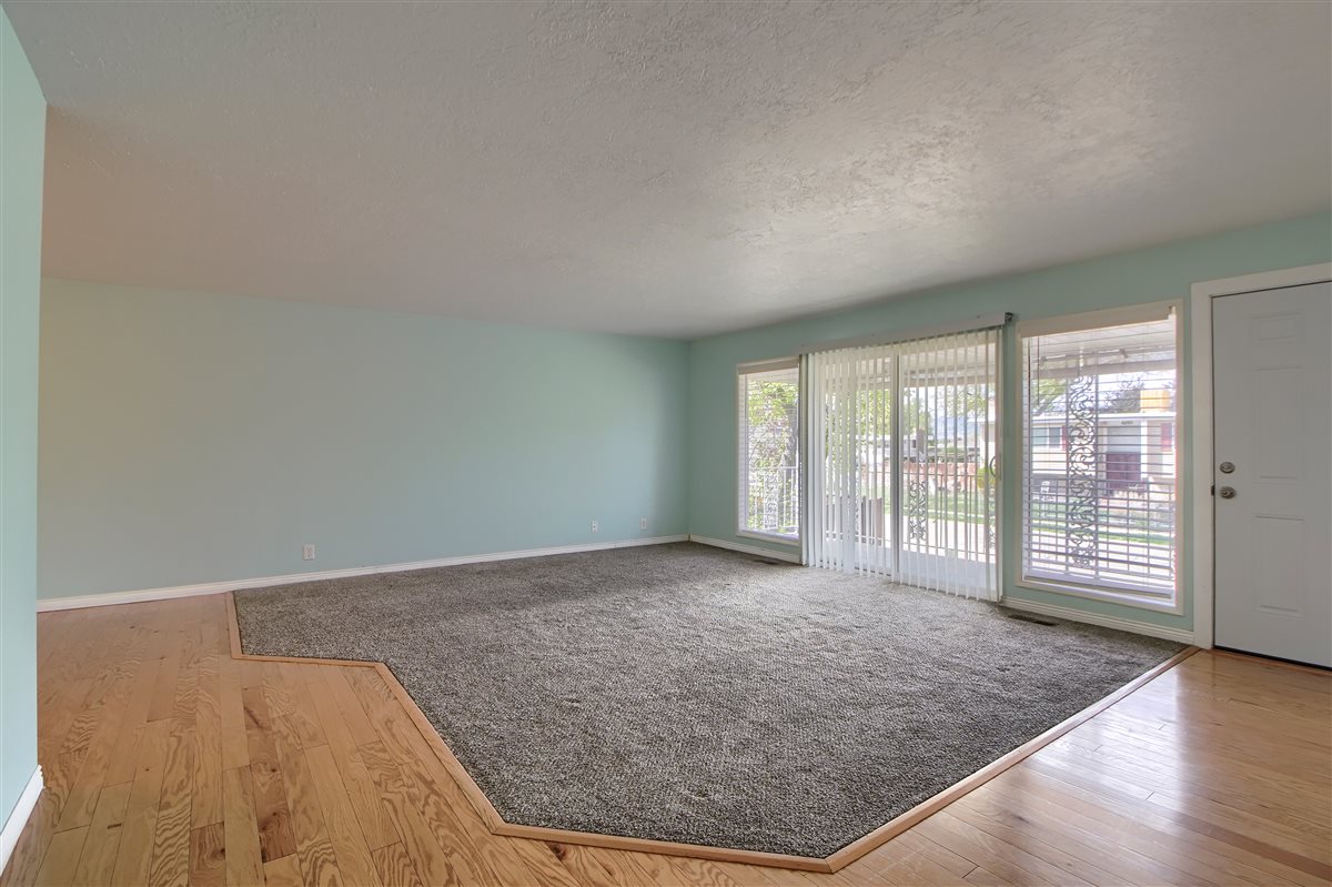 Unfurnished living room with hardwood / wood-style flooring and a textured ceiling